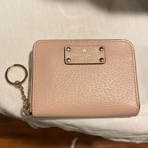 Pink zip around wallet with key ring.